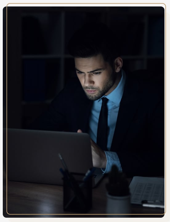 Thuro Accounting - Man working on a laptop in the dark